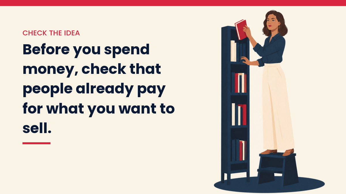 V, the VivaMomentum character, researching among library books. Text: Before you spend money, check that people already pay for what you want to sell.